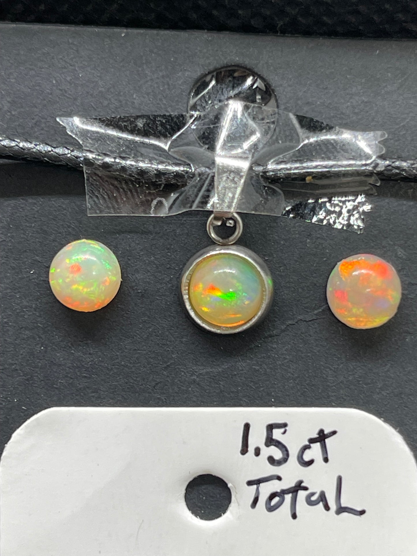E, necklace, and stud earrings